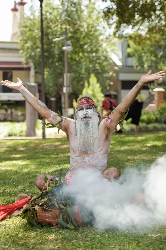 Aboriginal cultural performer conducting a traditional smoking ceremony at Glebe Street Fair Sydney