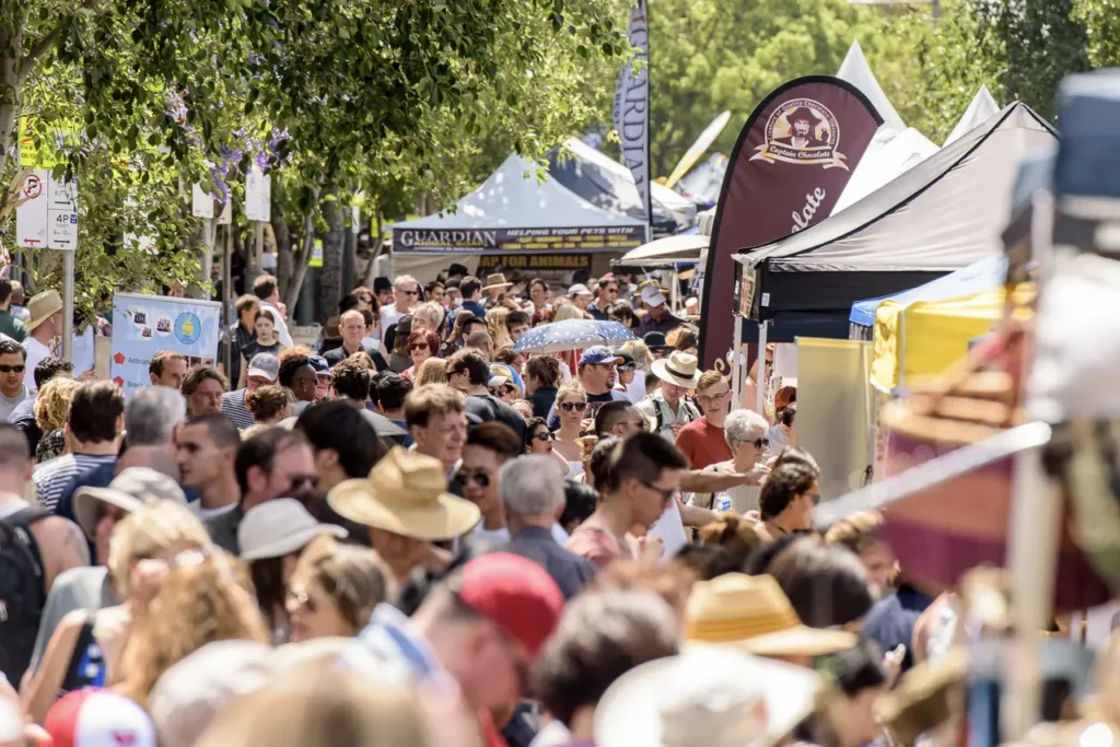Large crowds filling Glebe Point Road during Glebe Street Fair Sydney, showcasing the scale of the community festival