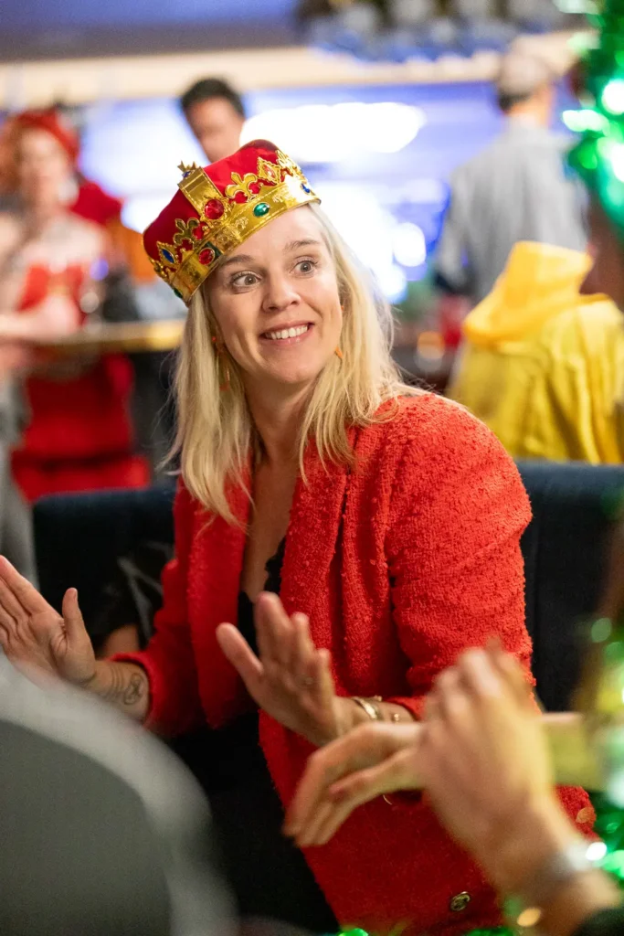 Smiling guest wearing a crown at a Sydney corporate costume party