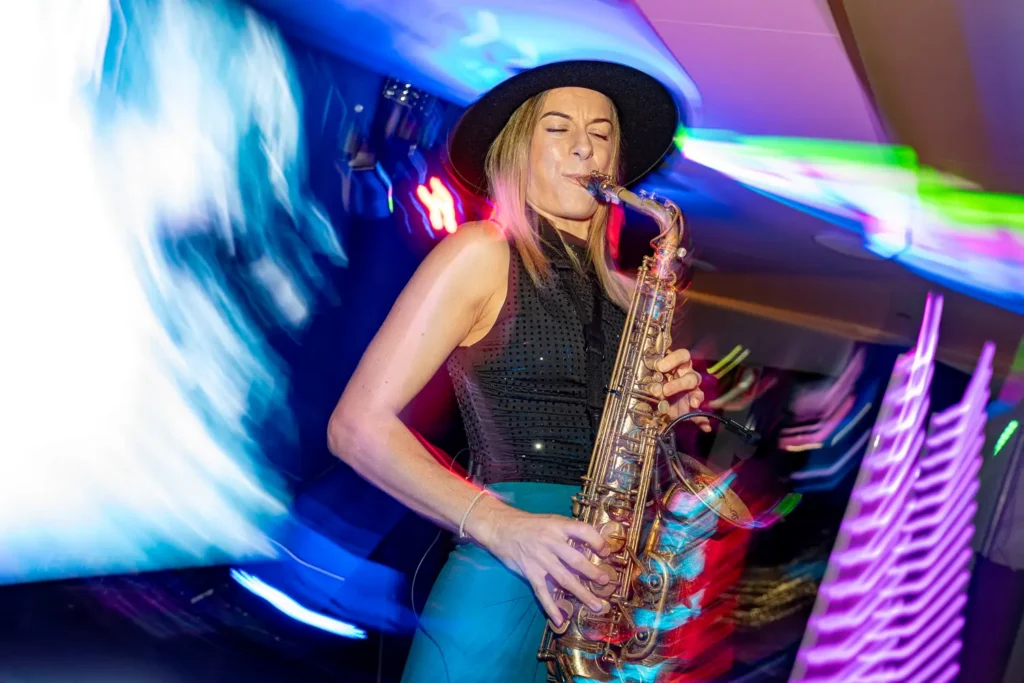 Saxophonist performing under colourful lights at a Sydney corporate event