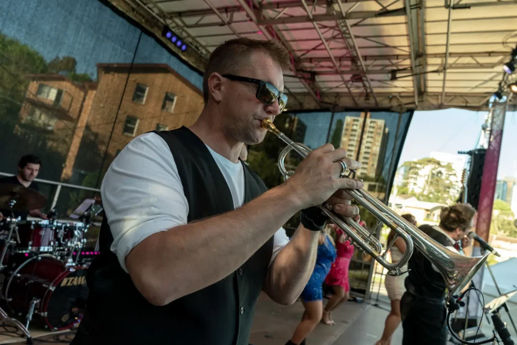 Trumpet player performing on stage at the North Sydney Sunset Series outdoor concert