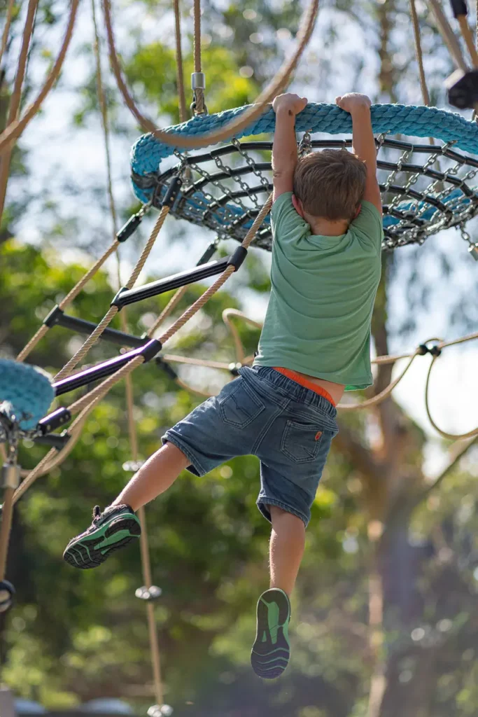 North Sydney event photography capturing a child climbing at the St Leonards Park playground opening