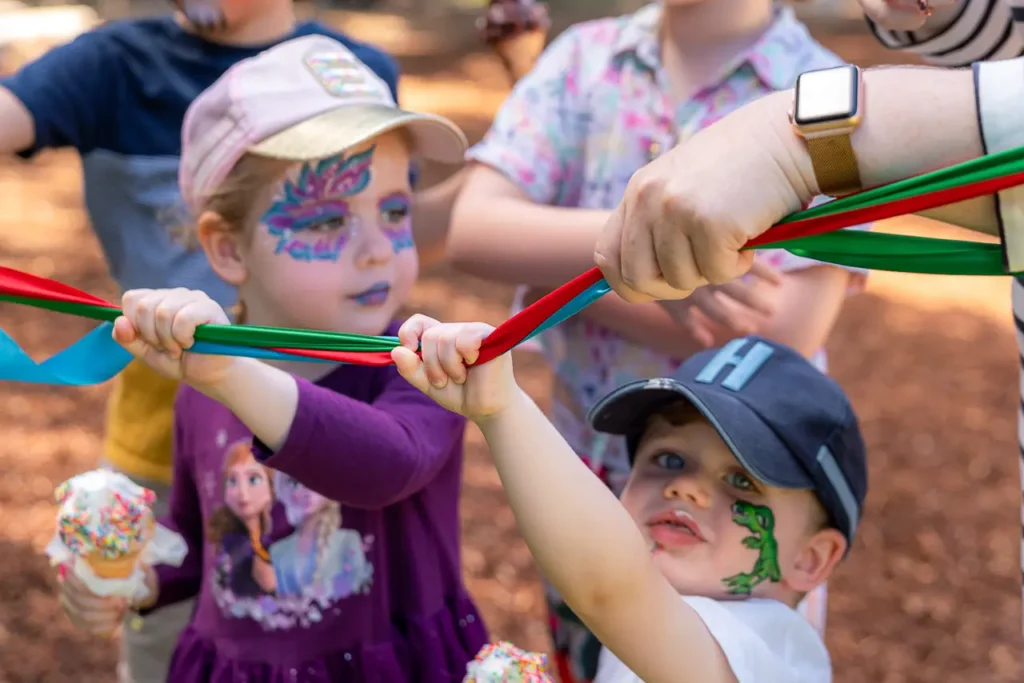 Event photography in North Sydney capturing children joining the ribbon cutting at the St Leonards Park opening
