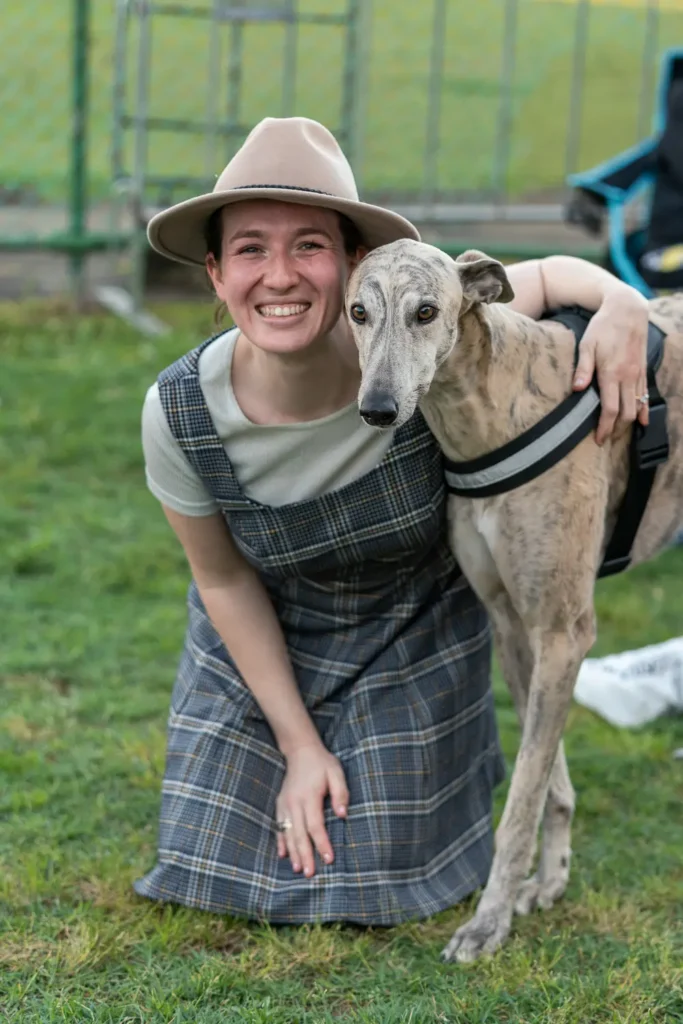Woman posing with her greyhound at the North Sydney Sunset Series community festival