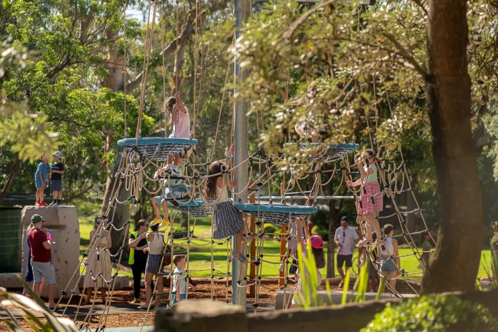 Event photography showing children exploring the climbing playground at St Leonards Park in North Sydney