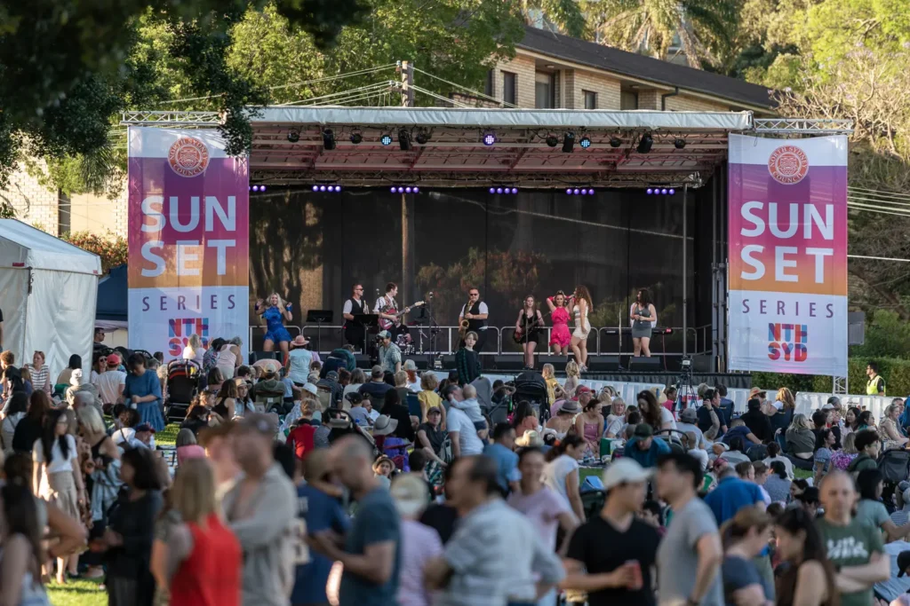 Wide view of the Sunset Series stage and large crowd enjoying live music at Waverton Park