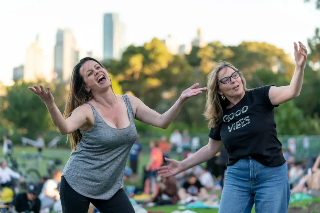 Two women dancing joyfully at the Sunset Series outdoor music festival in North Sydney