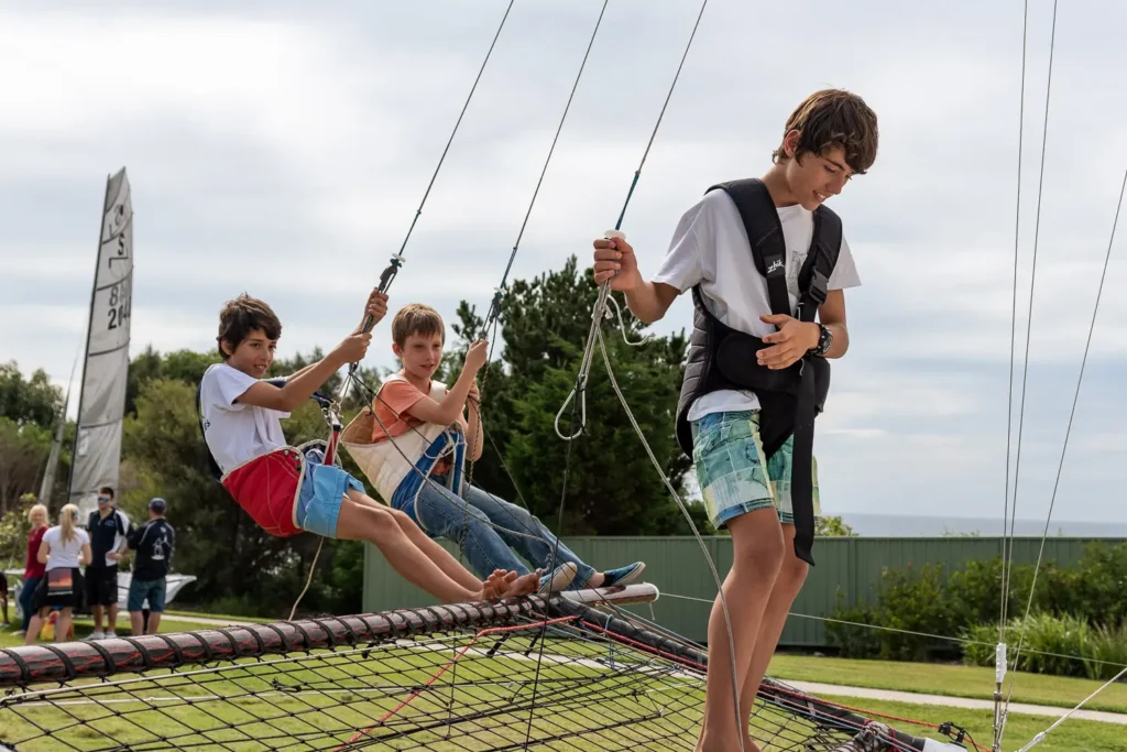 Young visitors exploring an interactive sailing display at a Sydney expo