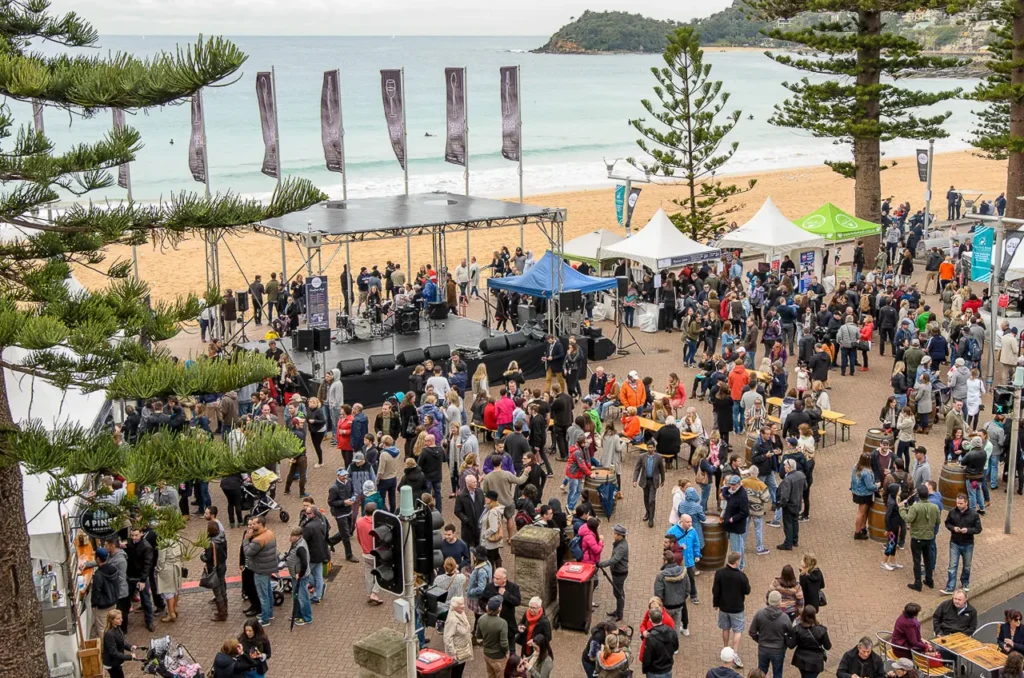 Elevated view of the Taste of Manly festival with stage, crowds and Manly Beach