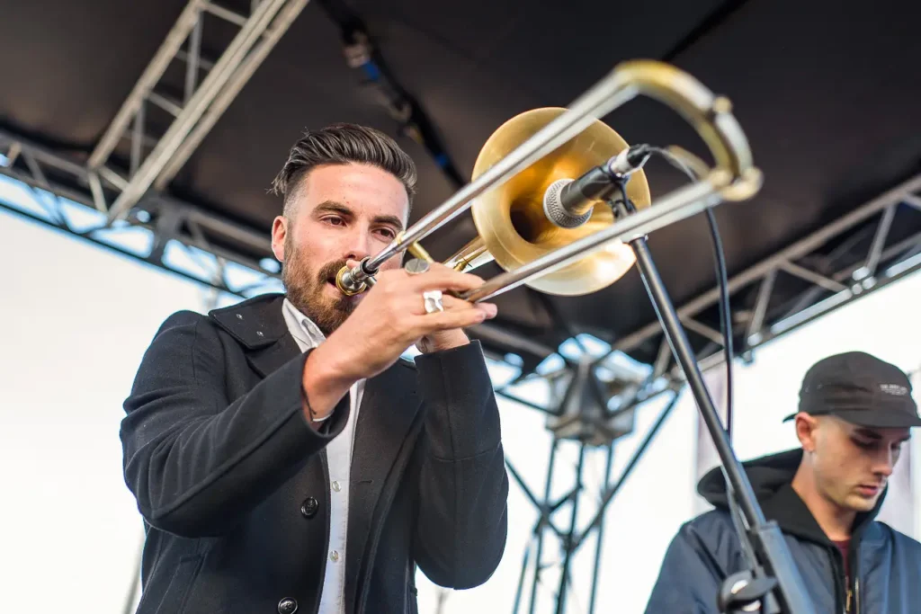 Trombone player performing live on stage at the Taste of Manly festival