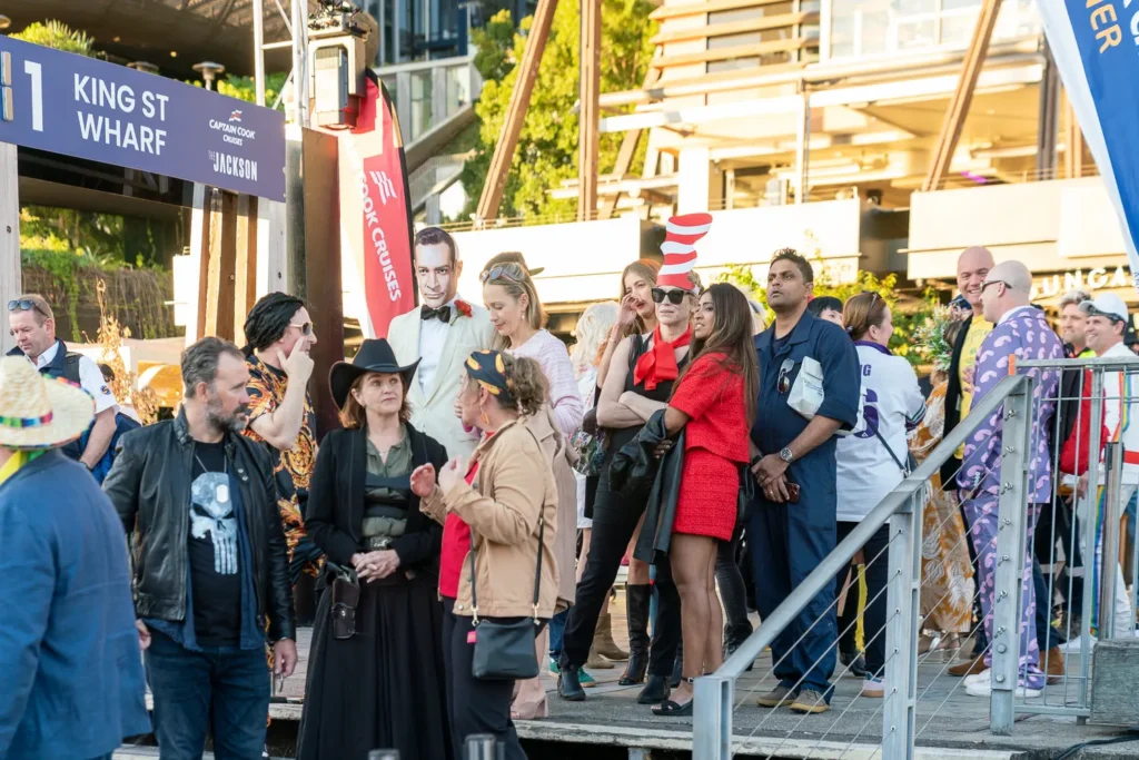 Costume party guests gathering at King Street Wharf before boarding The Jackson